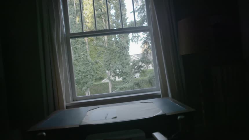 An open window near a desk during the day