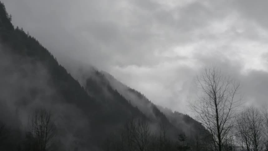 A foggy mountainside on a cloudy day