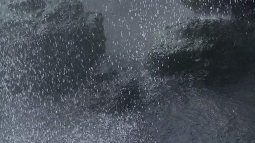 Water splashes down on boulders in the wilderness