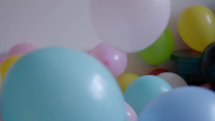 A toddler plays in a balloon pit