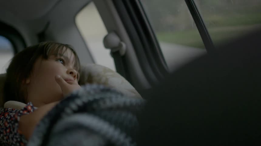A girl rides in her carseat in a vehicle