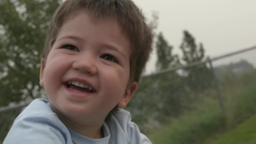 A young boy laughs and smiles