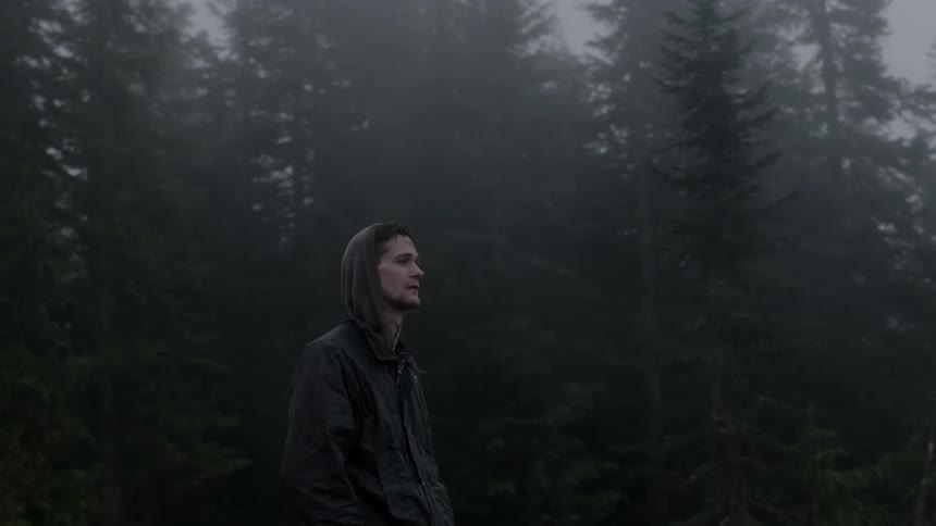 A man stands in the woods