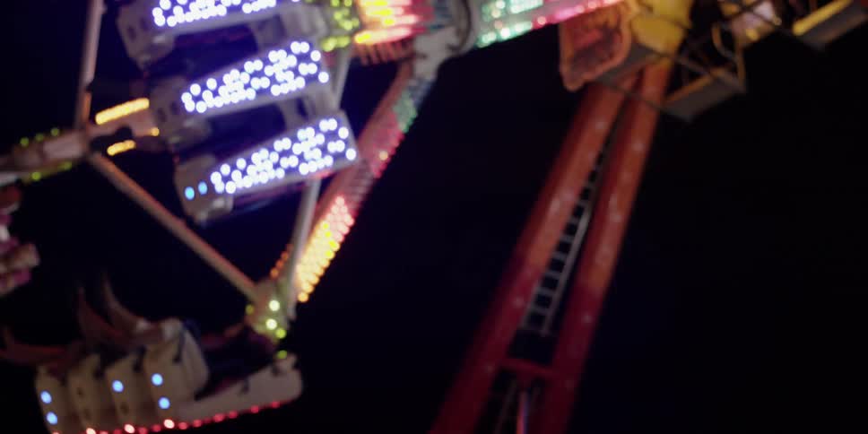 A carnival ride swings and rotates in the air