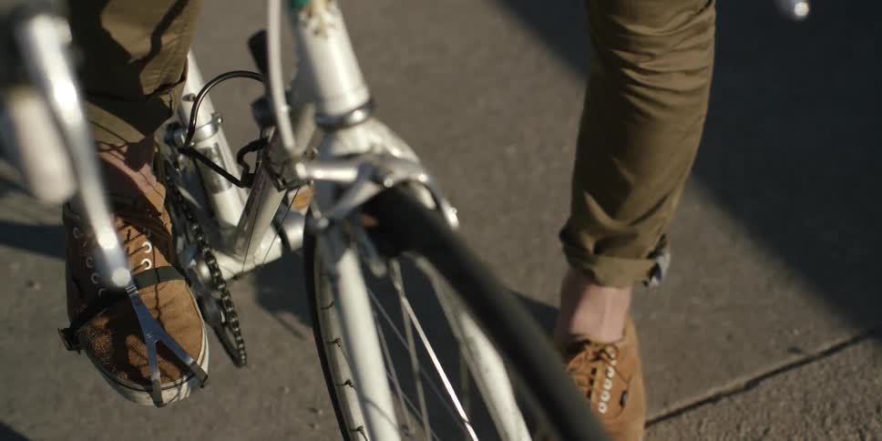 A person is about to ride a bike in the day time