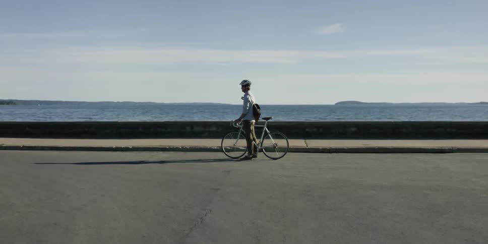 Man riding a bike near waterfront