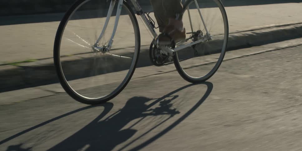 A person rides a bike on a street during the day