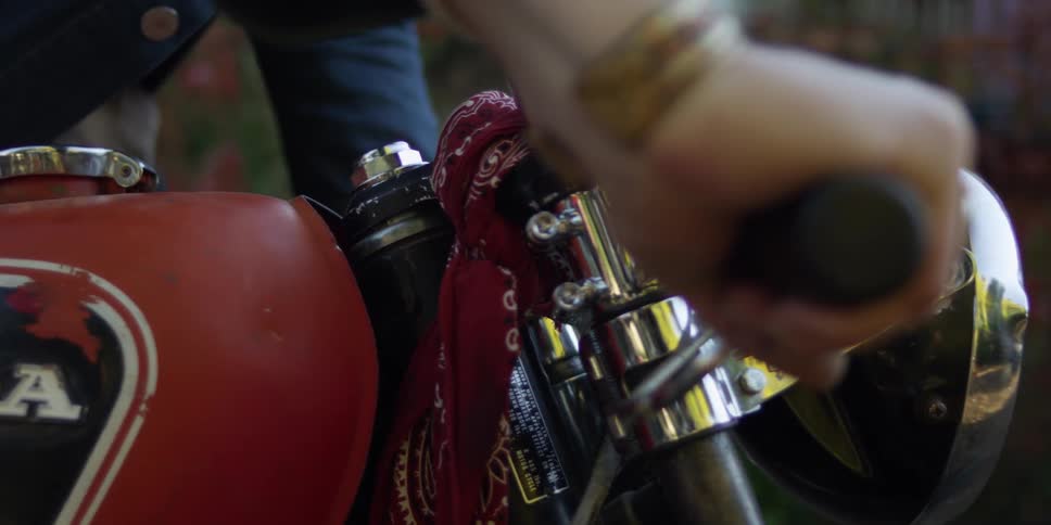 Close up of a hand on a motorcycle handlebar