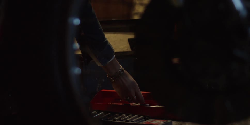 A man rifles through a toolbox