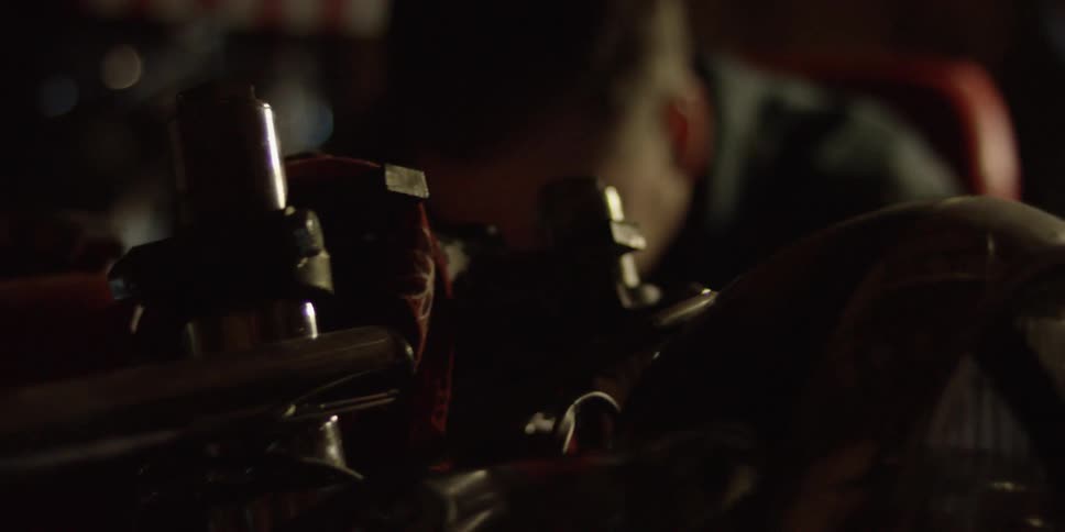 A man works on a motorcycle