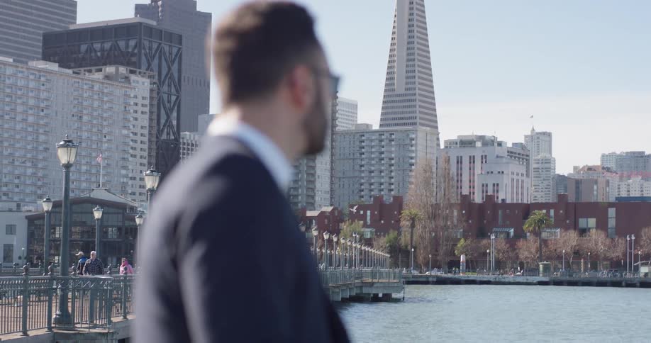 Man wearing sunglasses looks around at the city