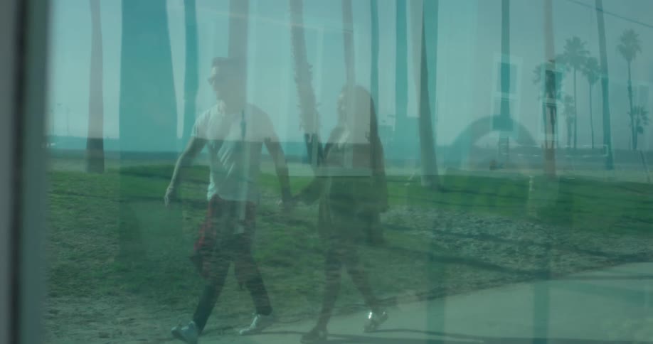 A man and woman hold hands as they walk