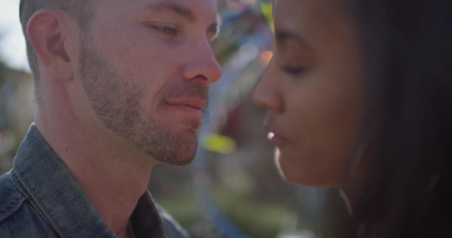 A man and woman embrace and kiss