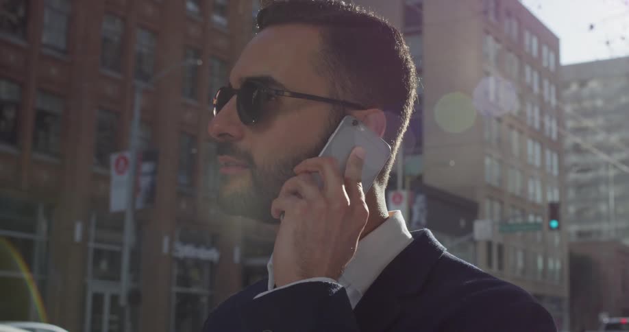 A man uses his phone outside in the city