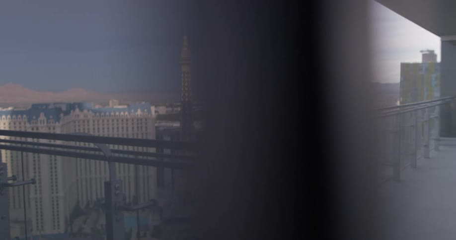 A woman uses a phone on the balcony