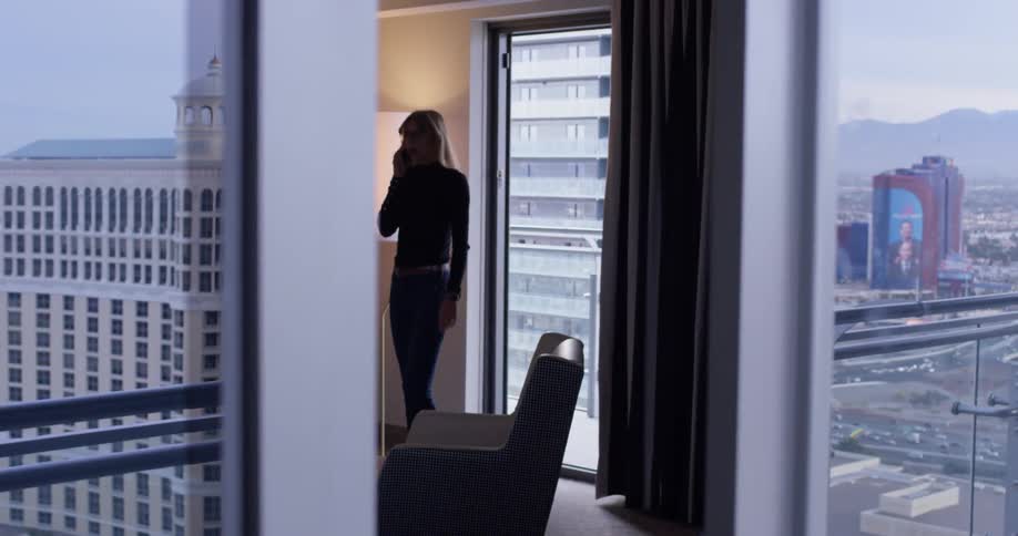 A woman uses her phone inside the apartment