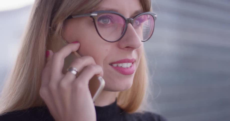 Woman is talking on cell phone on sunny day