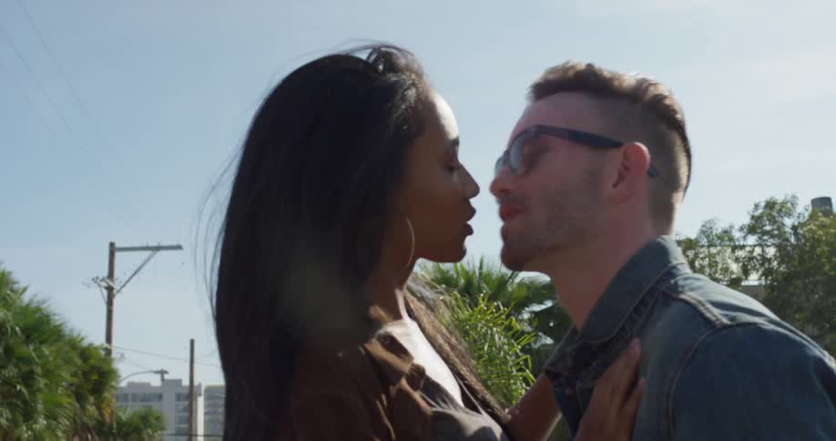 A man and woman embrace and kiss