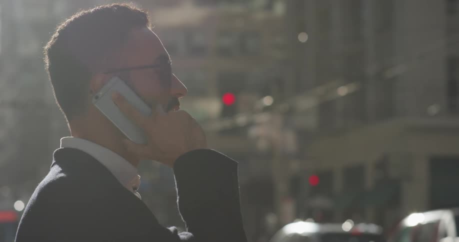 A man uses his phone outside in the city