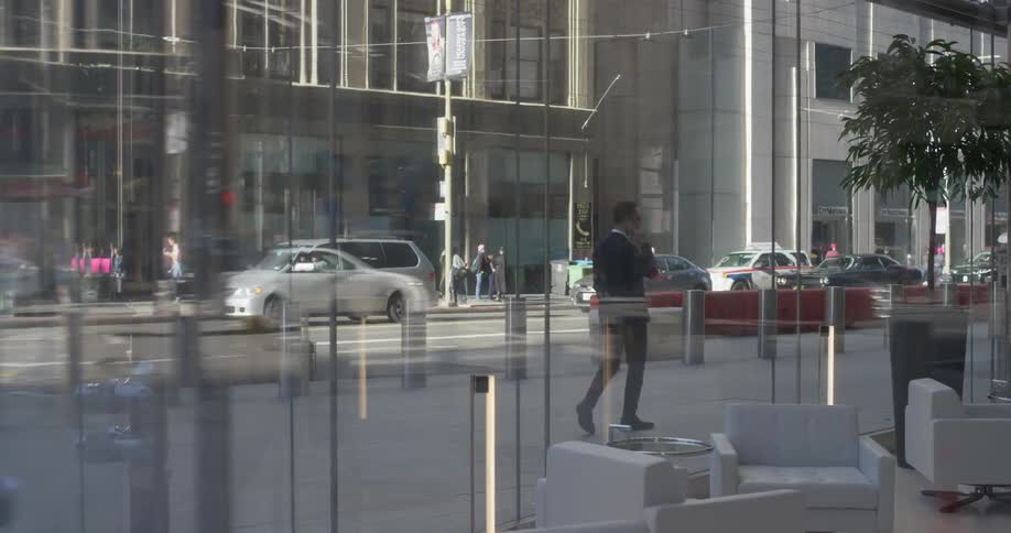 Cars and pedestrians travel in a city