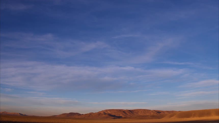 Hills sit under the blue sky