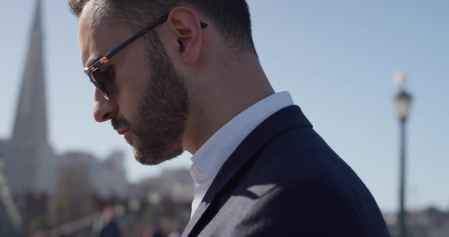 A businessman stands outside