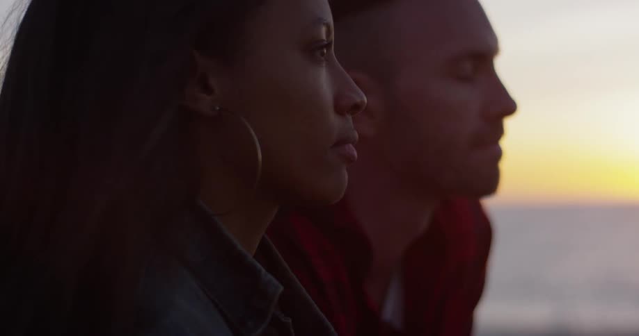 Man and woman talk as they sit close together