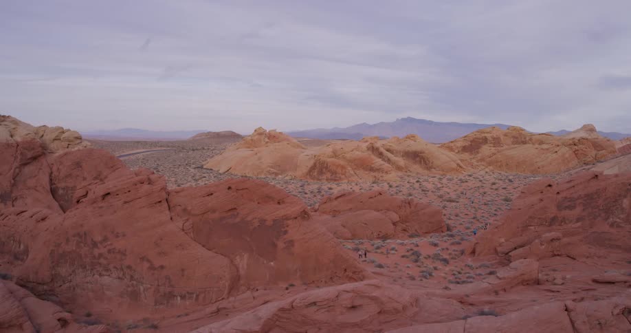 Wispy clouds over rocky hilly desert