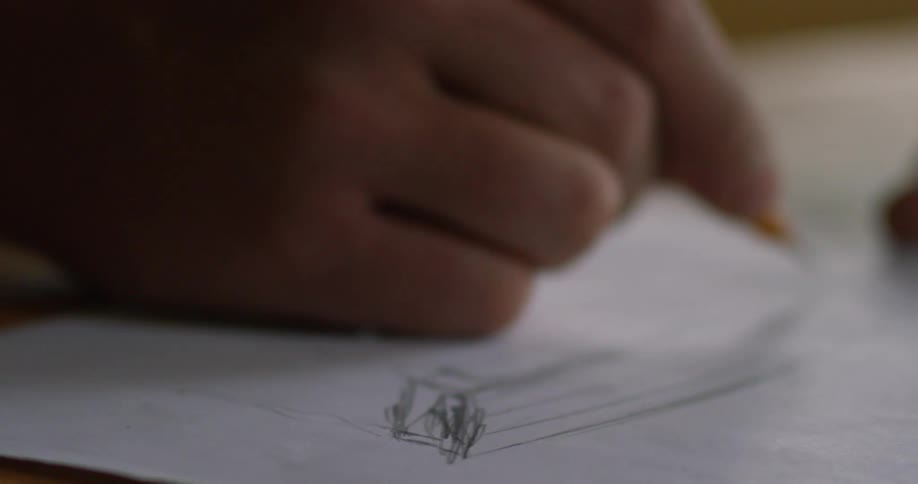 A person is drawing on a paper with a pencil