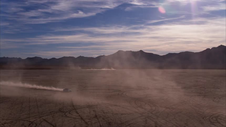 Dirt is kicked up by a speeding car