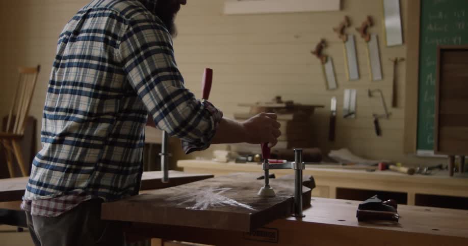 Man in workshop prepares to work on  woodworking project