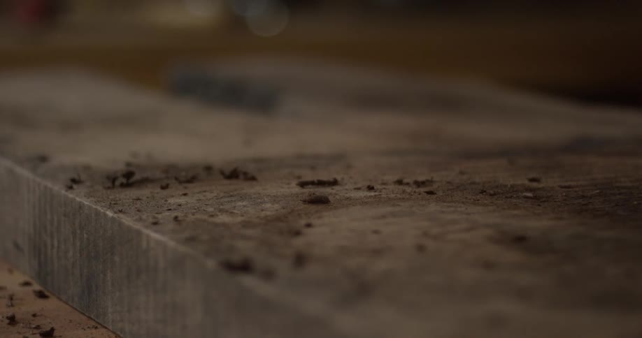 Male hands in close-up planing a piece of wood