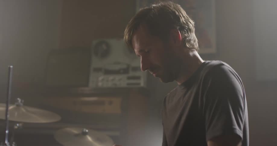 A man sits at a drum set