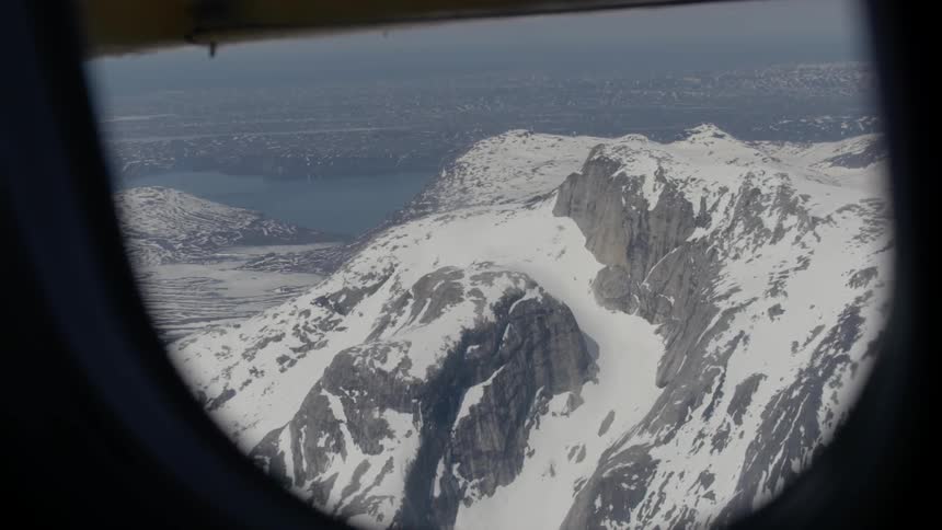 Snow covered mountain as seen from an airplane window