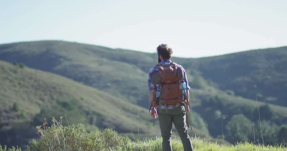 A hiker walks atop the hill