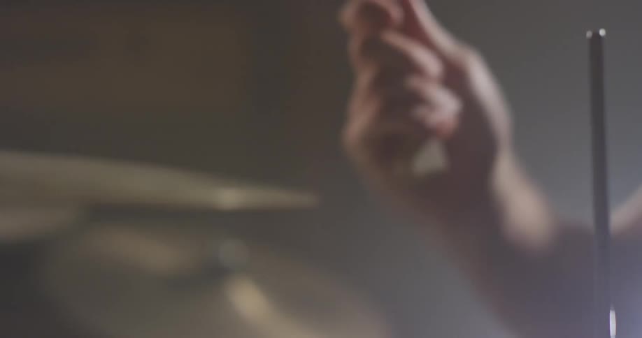 A drummer plays on the drum kit