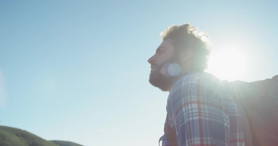 A hiker looks around outside