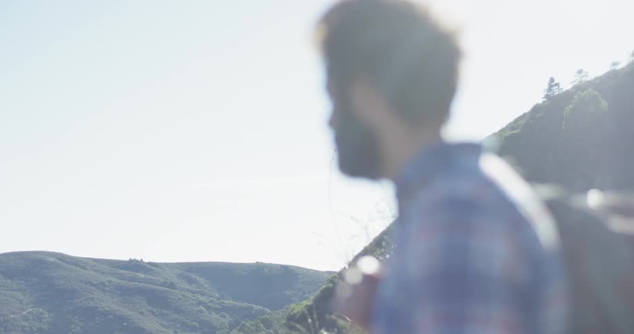 A hiker looks out from atop the mountain