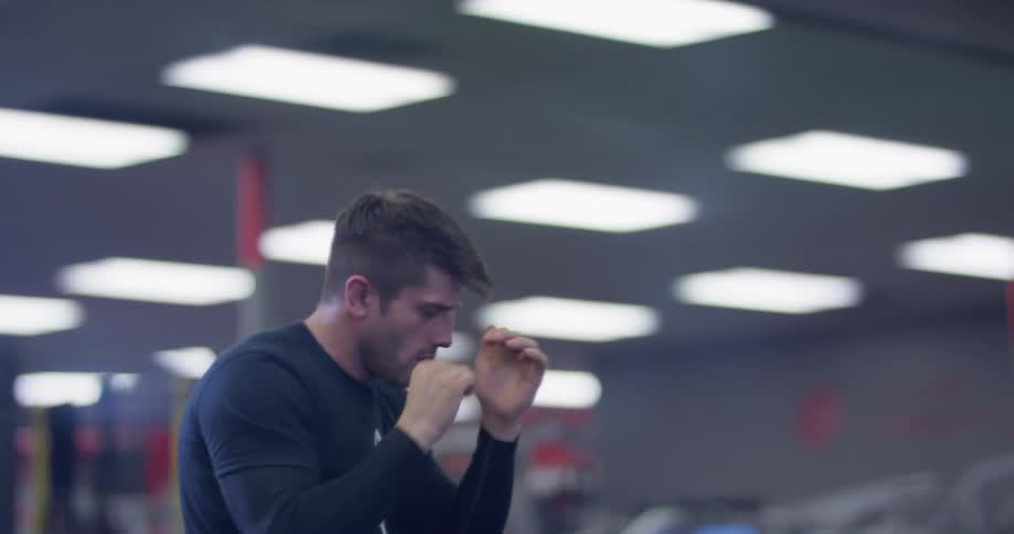 A man shadow boxes in a gym