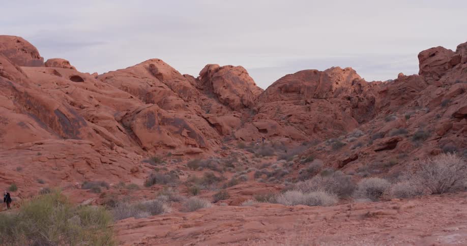Heavy clouds are hanging over a desert landscape during the day