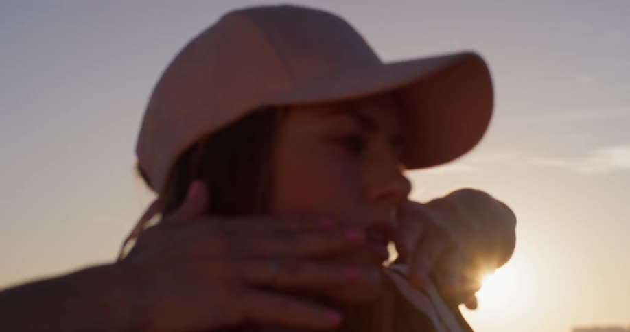 Woman dances outside at sunset