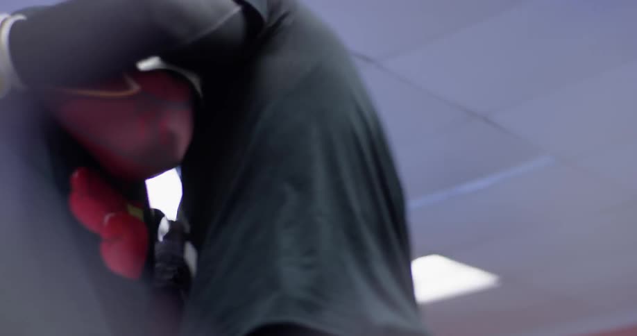 A man is boxing another man in the gym