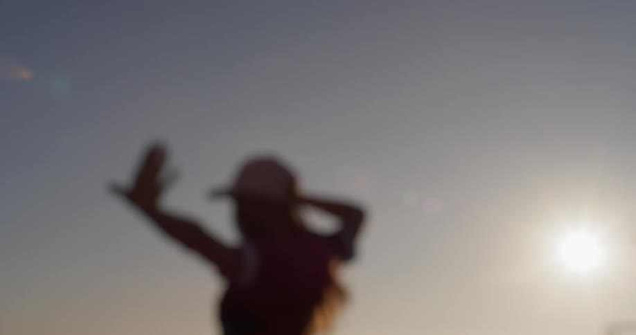 A woman dances on a building rooftop