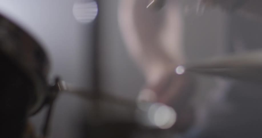 A drummer is playing drums indoors in daylight