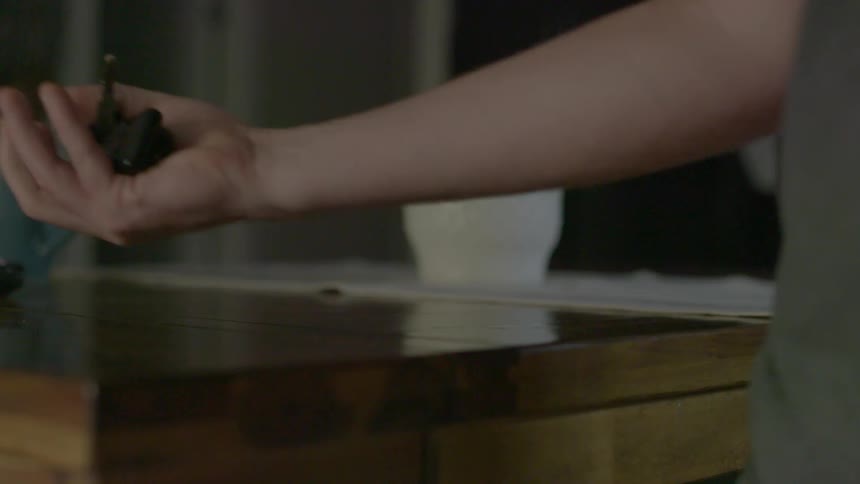 A man picking a set of keys up from a table