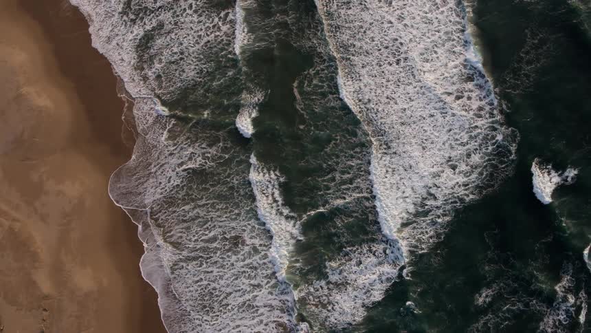 The tide flows onto the sandy shore