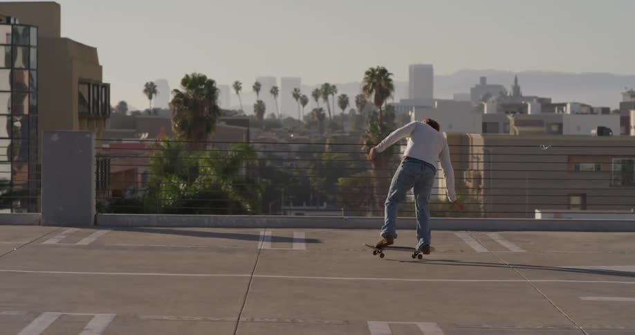 Man skateboarding in urban parking lot