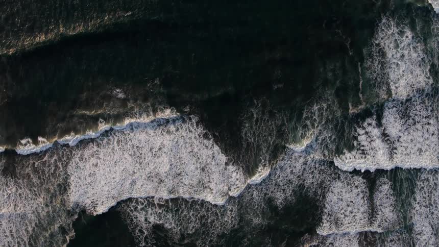 Ocean waves flow towards a shoreline