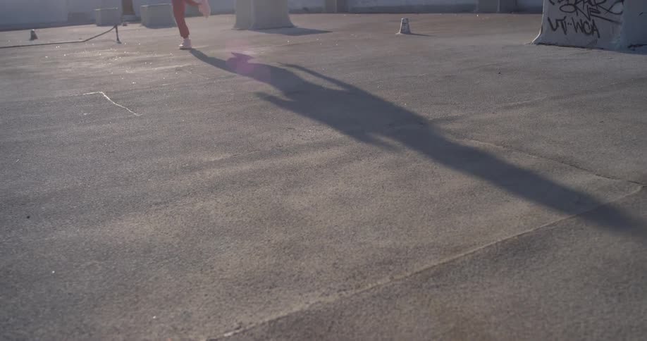 A woman dances on the building rooftop