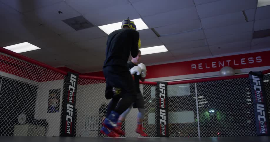Two men spar in a mma ring